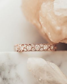 a diamond ring sitting on top of a rock