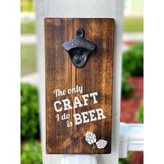 a wooden sign that says the only craft do's beer on it is hanging from a white post