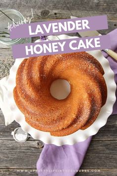 lavender honey cake on a white plate with purple napkin