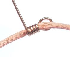 a close up of a wire with a knot on it's end and a hook in the middle