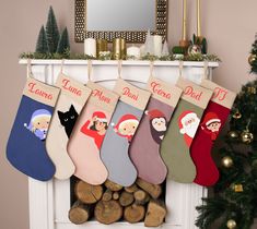 christmas stockings hanging from a mantel decorated with cartoon characters