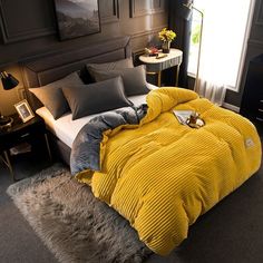 a yellow comforter on a bed in a bedroom