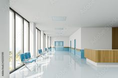 an empty room with blue chairs and large windows