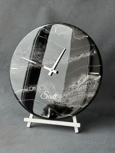 a black and white marble clock with the word soul written on it's face