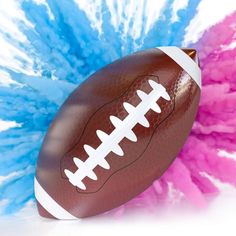 an american football with pink, blue and white pom - poms on it