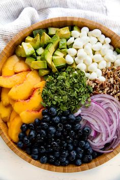 a wooden bowl filled with fruits and vegetables