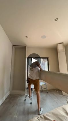 a man is painting the walls in his house