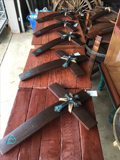 several wooden crosses are lined up on a table