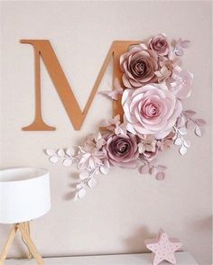 the letter m is made out of paper flowers