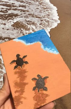 a hand holding up a piece of paper with an image of a turtle on it