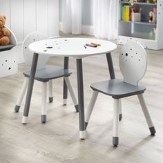 a child's table and chair set with teddy bear