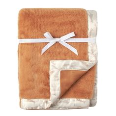 a blanket with a white ribbon on it and a brown square in the middle that is folded