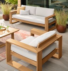 two wooden couches sitting on top of a hard wood floor next to a coffee table