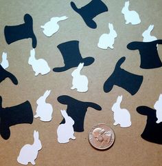 the silhouettes of rabbits in hats and tails are shown on a brown paper background