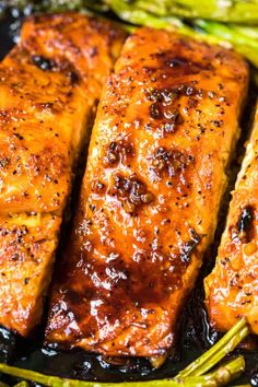 grilled salmon and asparagus on a black plate with brown sugar glaze