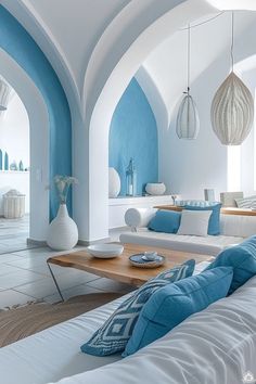 a living room filled with white and blue furniture