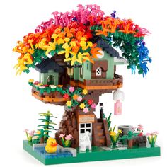 a lego tree house with colorful flowers on it