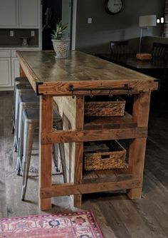 a kitchen island made out of wood with baskets on it