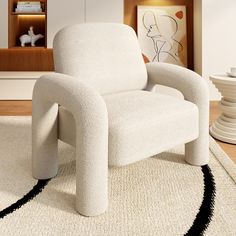 a white chair sitting on top of a rug in a living room