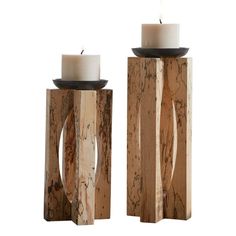 two wooden candlesticks sitting next to each other on top of a white background