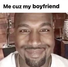 a man is smiling with the caption'me cuz my boyfriend'in front of him