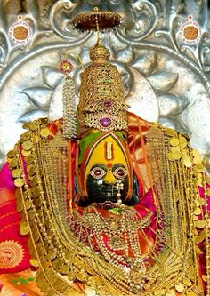 an idol is shown with gold chains around it