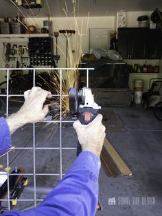 a man using a grinder to cut metal bars