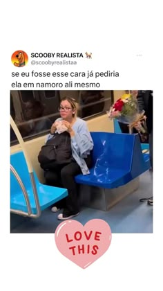 a woman sitting on a blue bench next to a red heart with the words love this