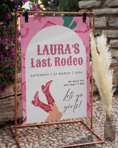 a sign advertising the last rodeo in front of some plants and flowers with pamolite