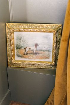 a painting hanging on the wall next to a chair