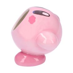 a pink pig shaped object sitting on top of a white surface