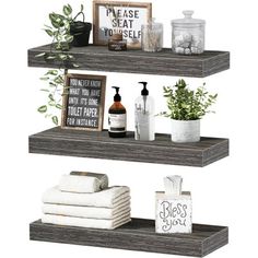 three shelves with towels, plants and other items on them