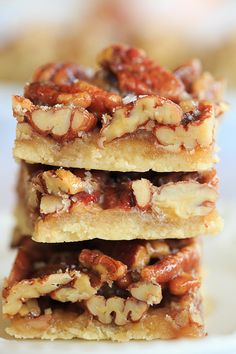 three pieces of pecan bars stacked on top of each other