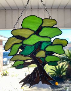 a stained glass tree hanging from a chain