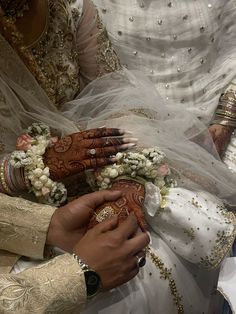 the bride and groom are holding each other's hands