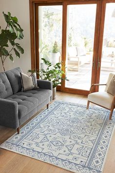 a living room filled with furniture and a blue rug