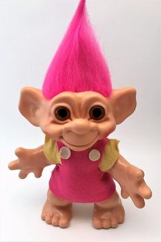 a troll doll with pink hair and big eyes