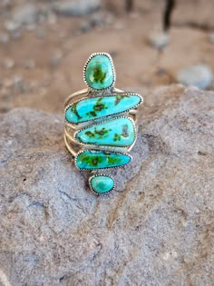 Expertly crafted with four freeform turquoise stones and a bold five shank design, the Patagonia turquoise ring is a true statement piece. Each stone is carefully selected for its unique beauty, making each ring truly one-of-a-kind. Elevate any outfit with this exquisite and versatile piece. Size is 7.5 but we can size it up one size or a 1/2 a size. Native American Artist: Smokey Gchache Native Turquoise Jewelry, Chunky Turquoise Jewelry, Turquoise Cowgirl, Raw Turquoise Ring, Real Turquoise Jewelry, Vintage Turquoise Jewelry, Turquoise Ring Engagement, Silversmithing Jewelry, Turquoise Jewelry Native American