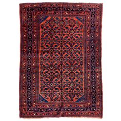 an antique persian rug with red and blue colors on the bottom, surrounded by ornate designs