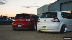 two cars parked next to each other in front of a building