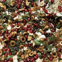 an assortment of food including mushrooms, feta cheese and pomegranates