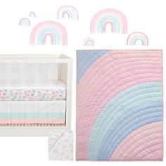 a baby crib with pastel rainbows and clouds