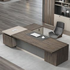 an office desk with a chair and laptop on it in the middle of a room