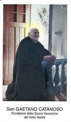 an old man is standing in front of a door wearing a black robe and holding a book