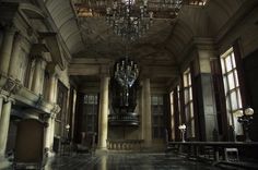 an empty room with chandeliers and windows