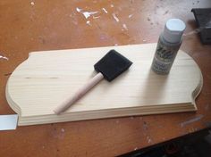 a hammer and some glue sitting on top of a wooden board