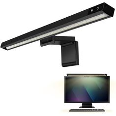 a computer monitor sitting next to a desk lamp