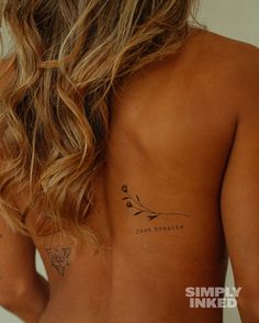 the back of a woman with tattoos on her body