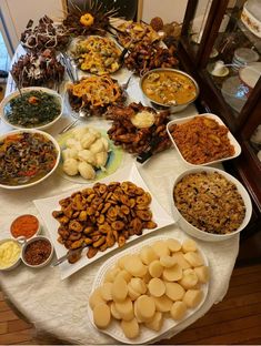 a table filled with lots of different types of food on top of plates and bowls