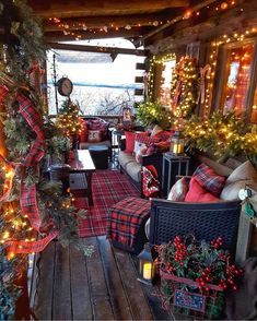 a living room decorated for christmas with red and green plaid furniture, garlands and lights